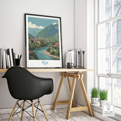 Peja Kosovo River Valley Art Print | Mountain Town Scenery Poster displayed in a modern workspace.