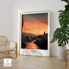 Peja Kosovo Sunset River Bridge Art Print | Mosque and Mountains Poster displayed in a modern interior with plants.