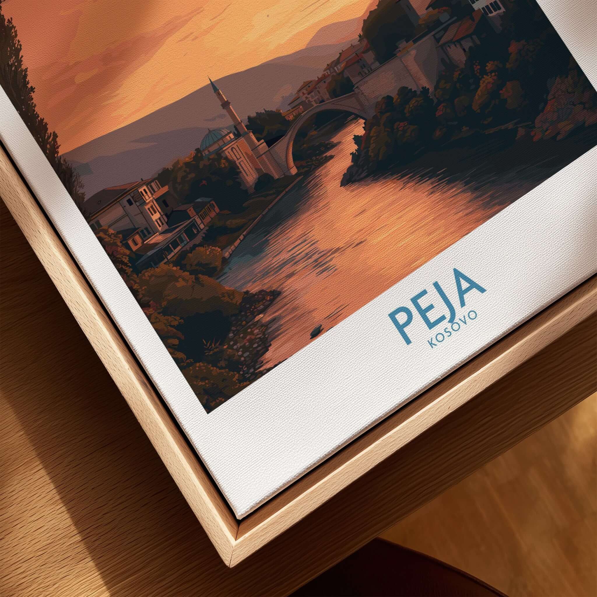 Peja Kosovo Sunset River Bridge Art Print | Mosque and Mountains Poster displayed in a wooden frame.