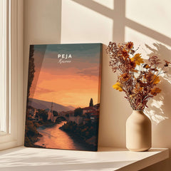 Peja Lumëbardhi River Twilight Canvas Print | Kosovo City Wall Decor displayed with flowers in a vase.
