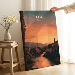 Peja Lumëbardhi River Twilight Canvas Print | Kosovo City Wall Decor displayed in a cozy setting with flowers.