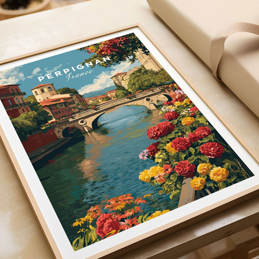 Perpignan cityscape art print featuring River Le Basse and vibrant flowers, perfect French village wall decor.