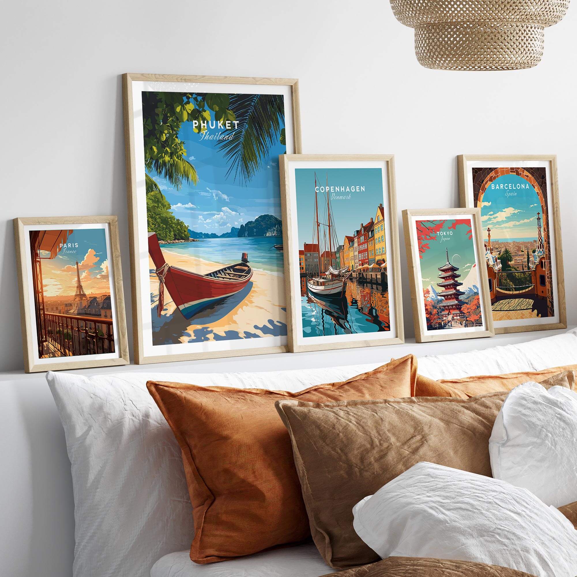 Phuket Travel Print displayed among various travel posters in a stylish home setting, showcasing vibrant tropical art.