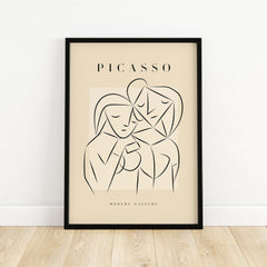 Picasso Abstract Couple Lovers Embrace Line Art Figures Poster Modern Gallery Wall Art framed against a beige wall.