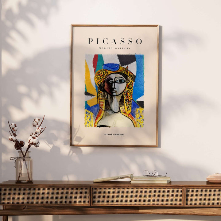Colorful Picasso abstract face portrait poster featuring geometric shapes and a yellow headdress in a modern gallery setting.