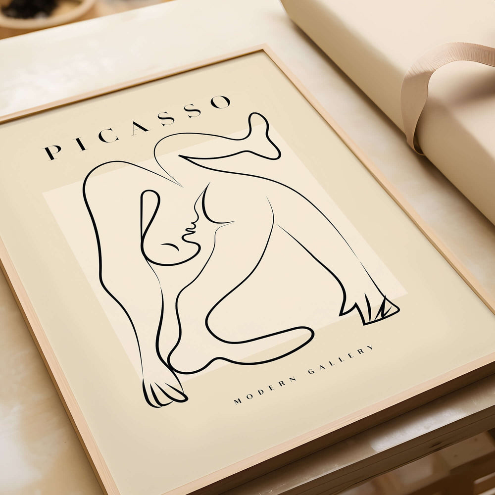 Picasso Contorted Figure Abstract Pose Line Art Modern Gallery Poster Wall Art framed on a tabletop in soft beige tones.