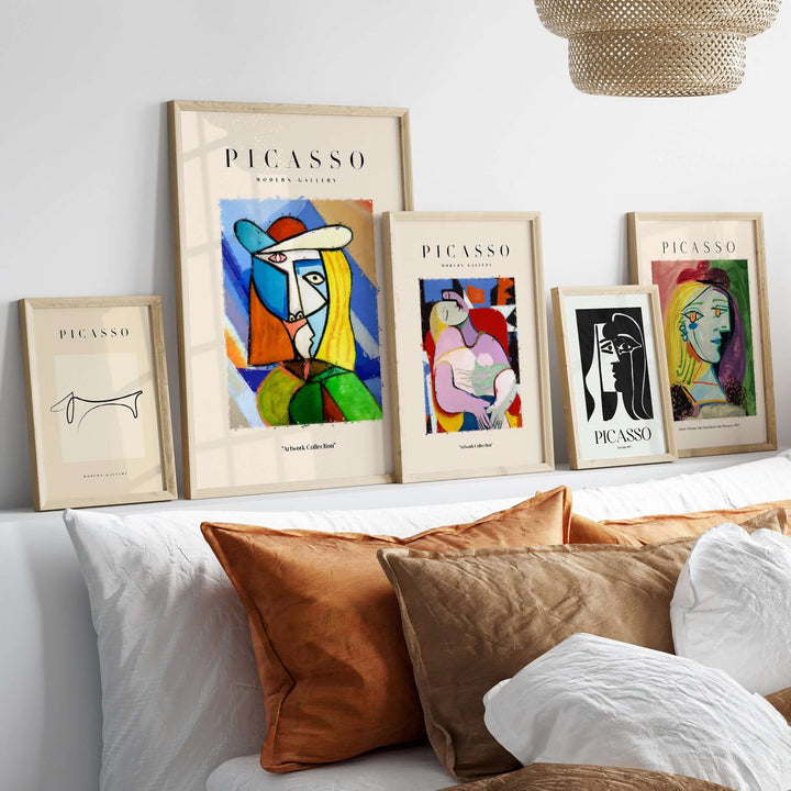 Display of framed Picasso-inspired abstract portraits on a modern wall, featuring vibrant colors and geometric shapes.