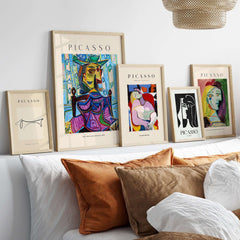 Image of framed Picasso art prints featuring various portraits and Cubist designs in a stylish interior setting.