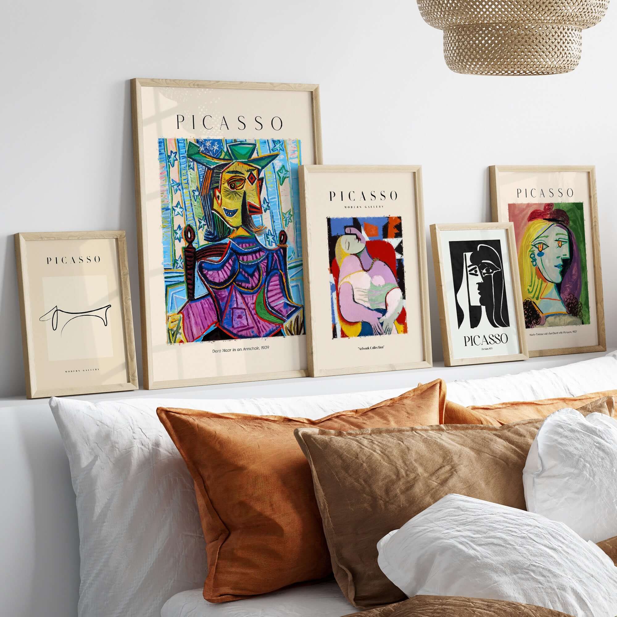 Image of framed Picasso art prints featuring various portraits and Cubist designs in a stylish interior setting.