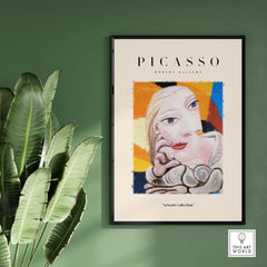 Picasso Blonde Woman Abstract Portrait Print Cubist Style Poster Artwork Collection on a wall with tropical plant