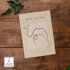 Picasso Camel Line Art Minimalist Animal Poster Modern Gallery Print Wall Art on wooden surface with greenery