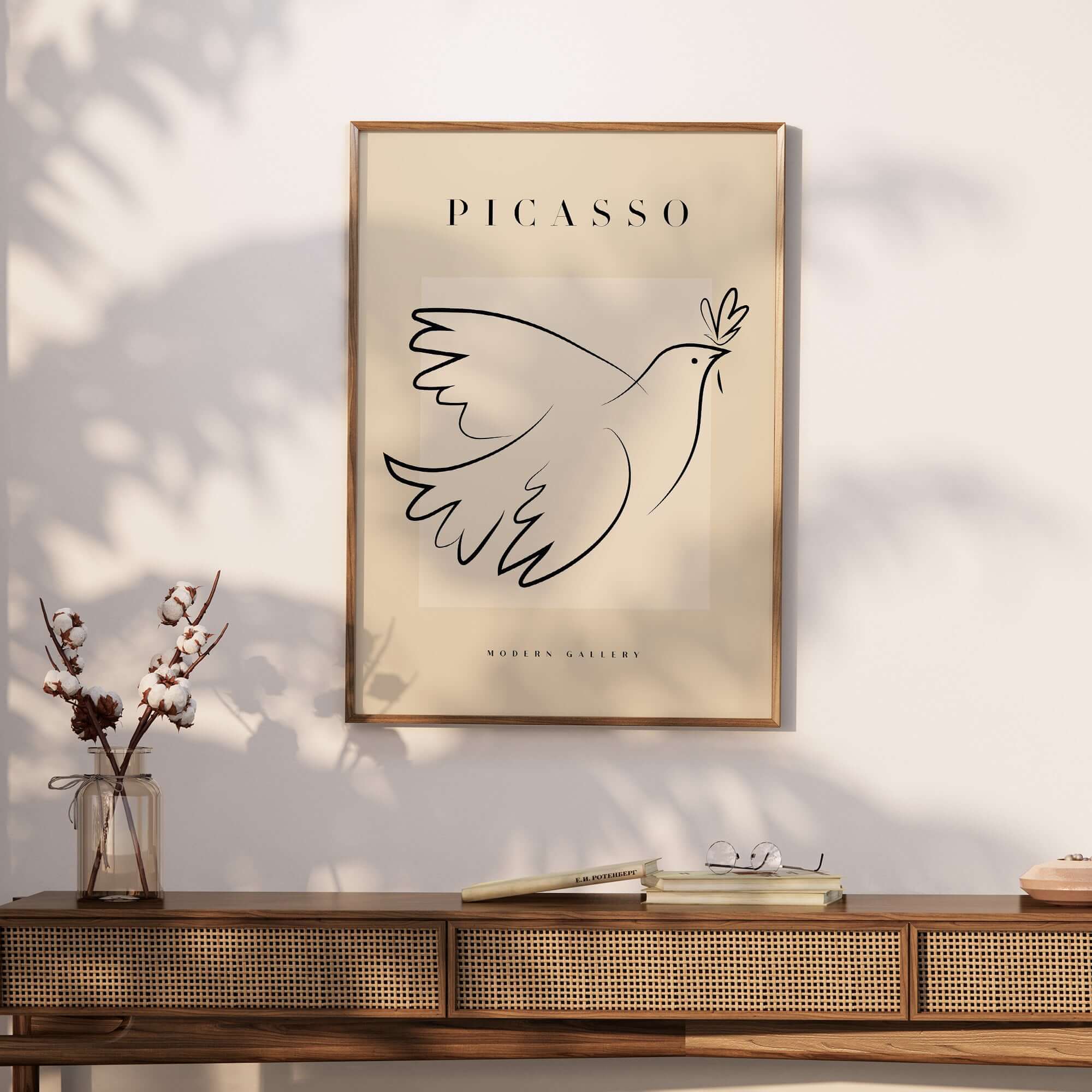 Picasso Dove of Peace Olive Branch Line Art Poster Modern Gallery Print displayed on a wall with a wooden table below.