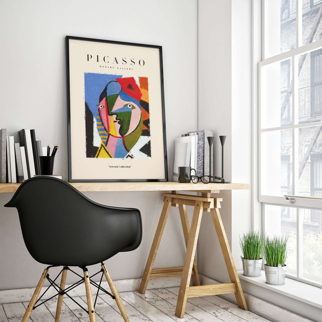 Colorful Picasso geometric face abstract art print in a modern workspace setting.