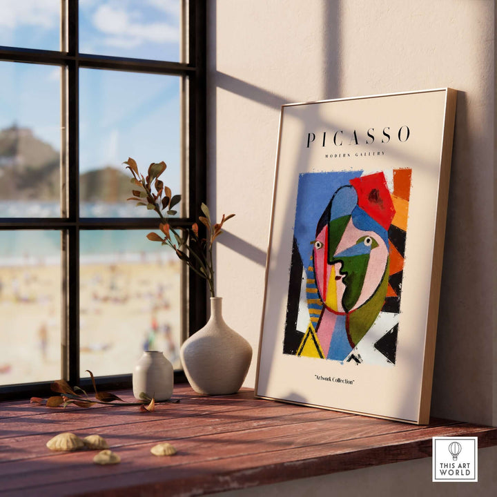 Colorful Picasso geometric abstract face art print displayed by a sunny window, featuring bold shapes and vibrant colors.