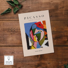 Picasso Geometric Face Abstract Art Print Colorful Cubist Portrait Poster Artwork Collection displayed on wooden background.