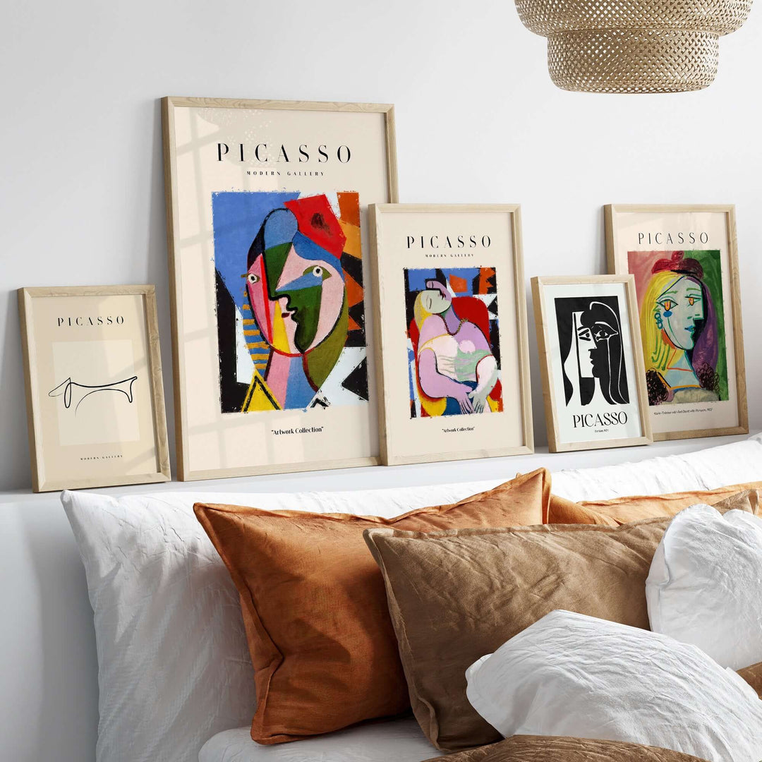 Colorful Picasso abstract art prints displayed in stylish frames on a modern shelf.