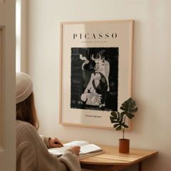 Picasso Guernica Inspired Bull Mother Figure Art Print Abstract Black White Poster Collection framed on wall with woman reading.