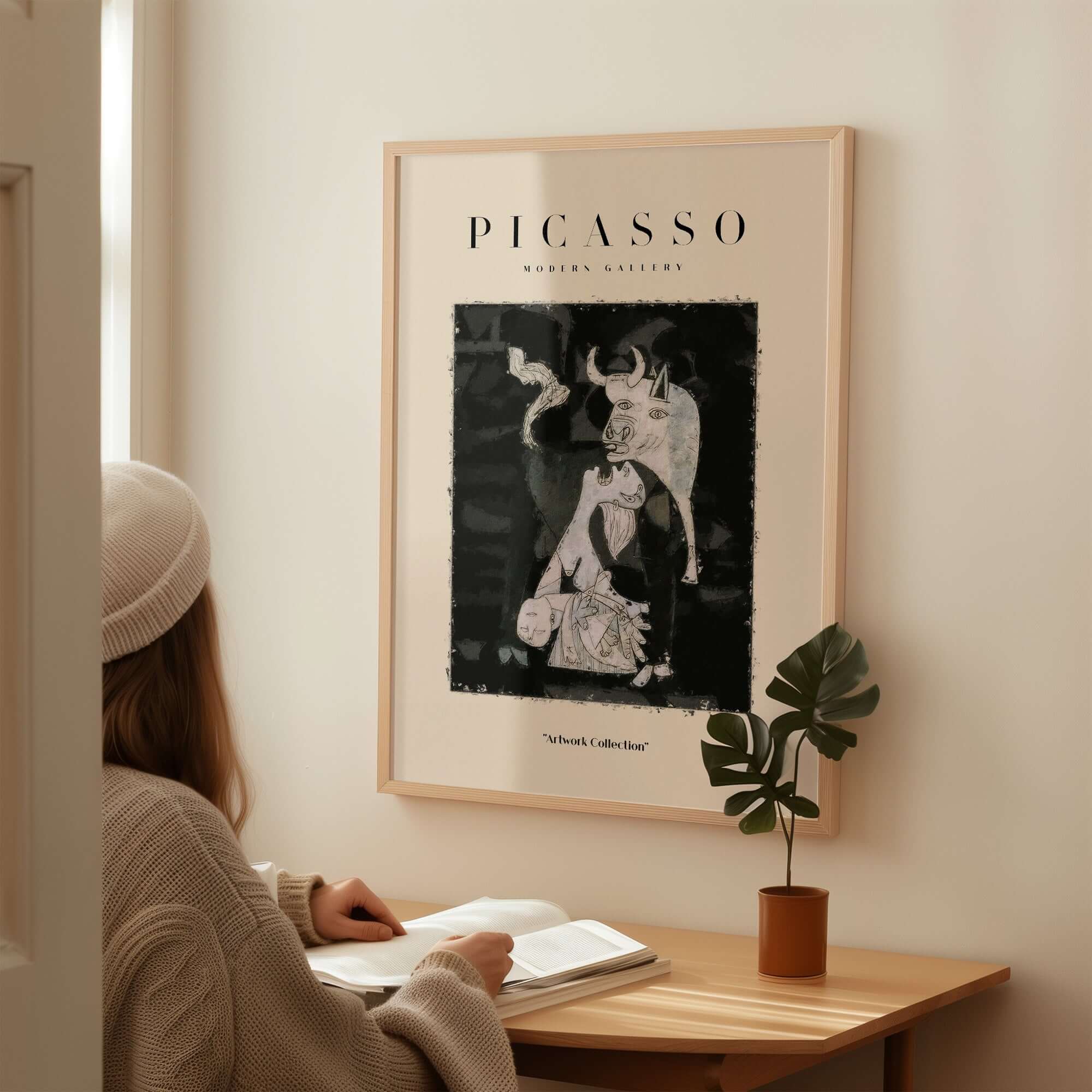 Picasso Guernica Inspired Bull Mother Figure Art Print Abstract Black White Poster Collection framed on wall with woman reading.