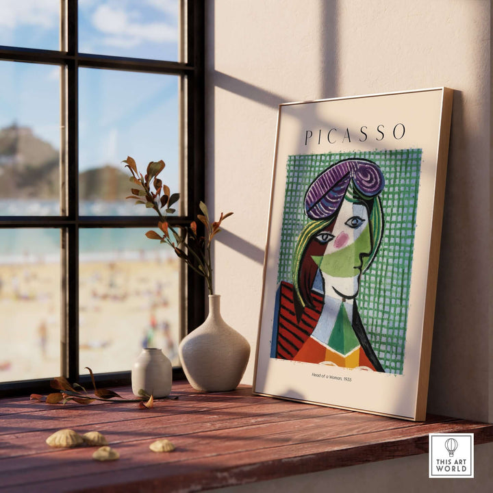 Colorful Picasso 'Head of a Woman' 1935 art print displayed in a stylish interior with a beach view.