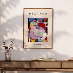 Picasso Le Rêve Inspired Reclining Woman Art Print Cubist Poster Artwork Collection hanging on a wall above a wooden console.
