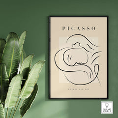 Picasso Line Art Reclining Sleeping Face Modern Gallery Poster Wall Art framed on wall with leaves.