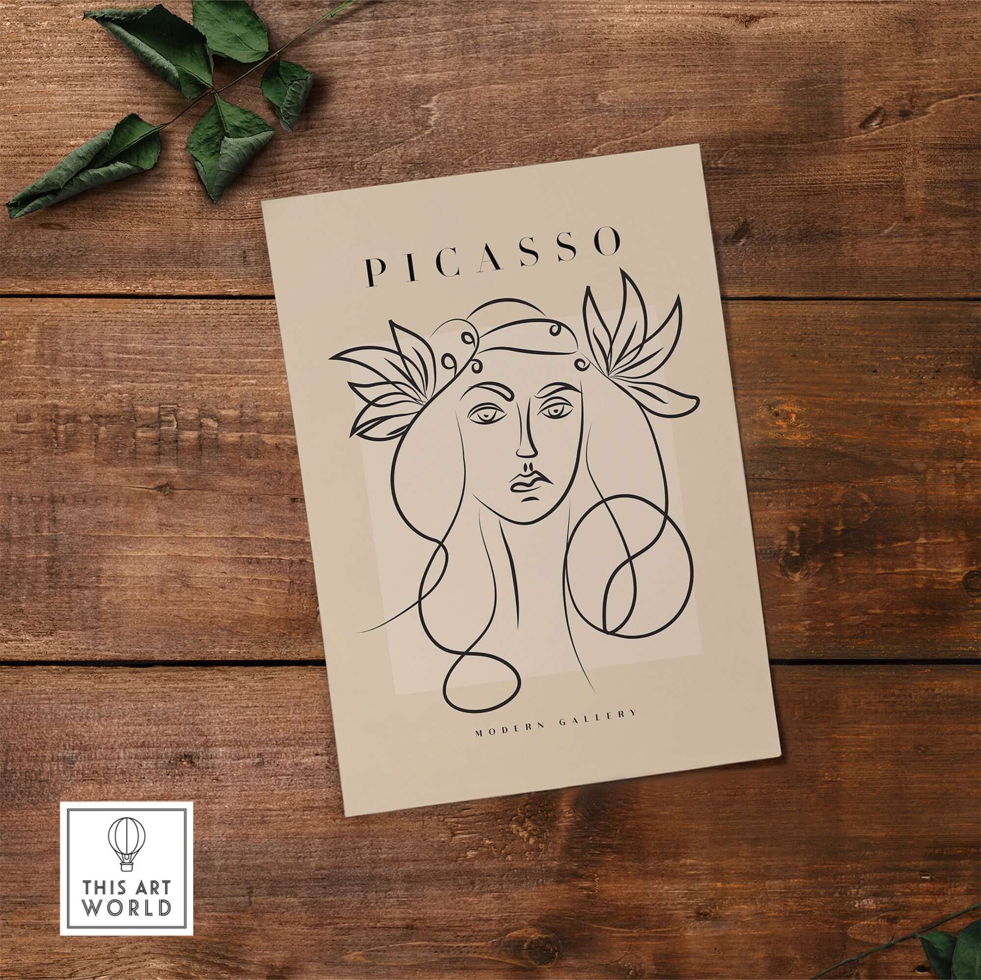 Picasso Line Art Woman Leaf Crown Modern Gallery Wall Art Poster displayed on a wooden surface with foliage.