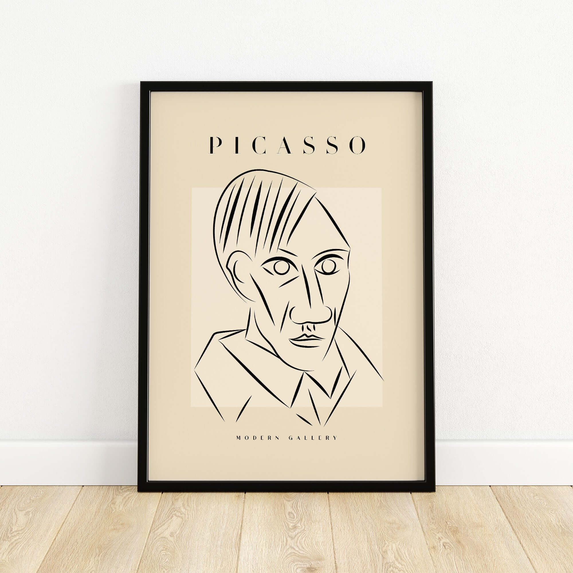 Picasso Man Portrait Sharp Lines Abstract Face Poster Modern Gallery Print Wall Art in a black frame on a wooden floor.