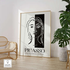 Picasso Portrait Deux Parties Black White Split Face Art Print Poster displayed in a modern room with bamboo chair.