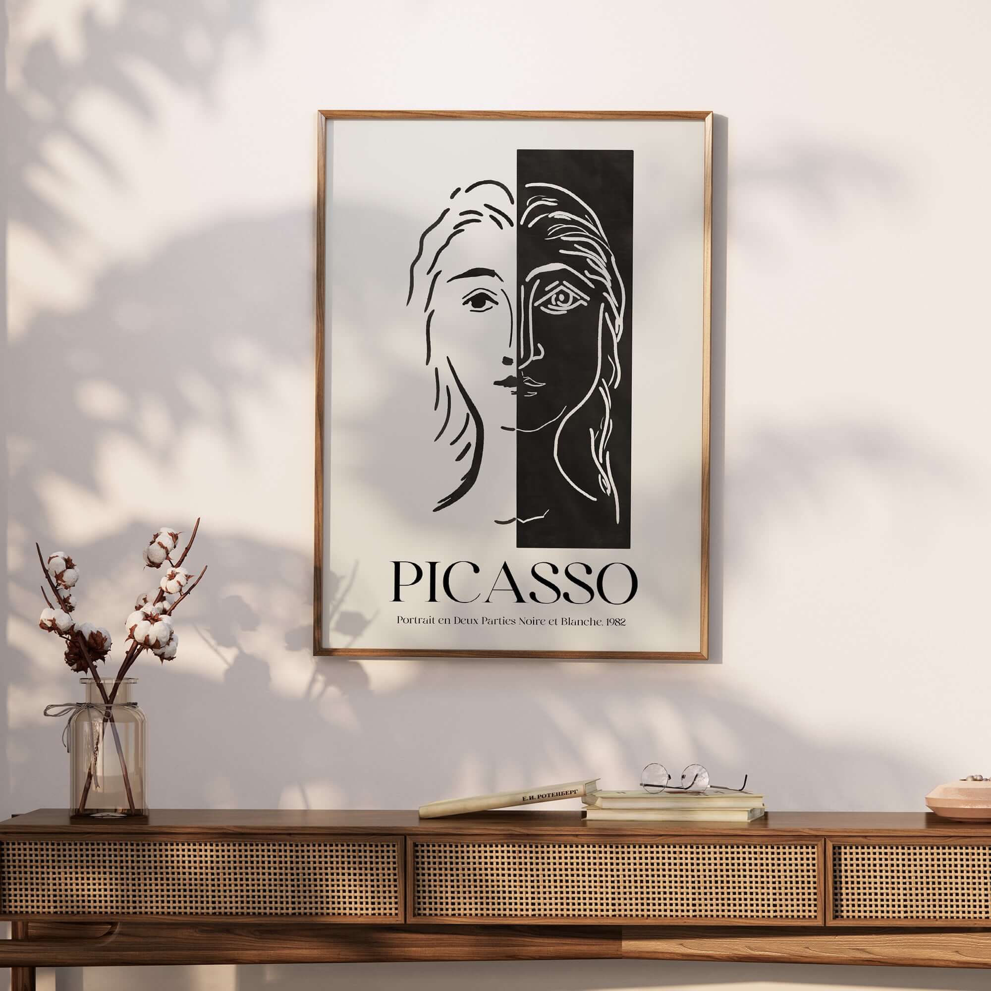 Picasso Portrait Deux Parties Black White Split Face Art Print Poster displayed on wall above a wooden console.