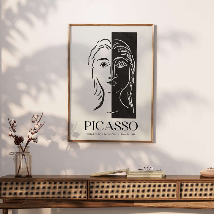 Picasso Portrait Deux Parties black and white split face art print poster on a wooden console table.