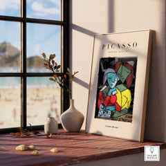 Picasso Reading Couple Abstract Figures Art Print Cubist Poster Artwork Collection displayed on a shelf by a window.