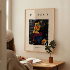 Picasso Seated Woman Cubist Portrait Art Print Modern Gallery Artwork Poster displayed on wall with a person admiring it.