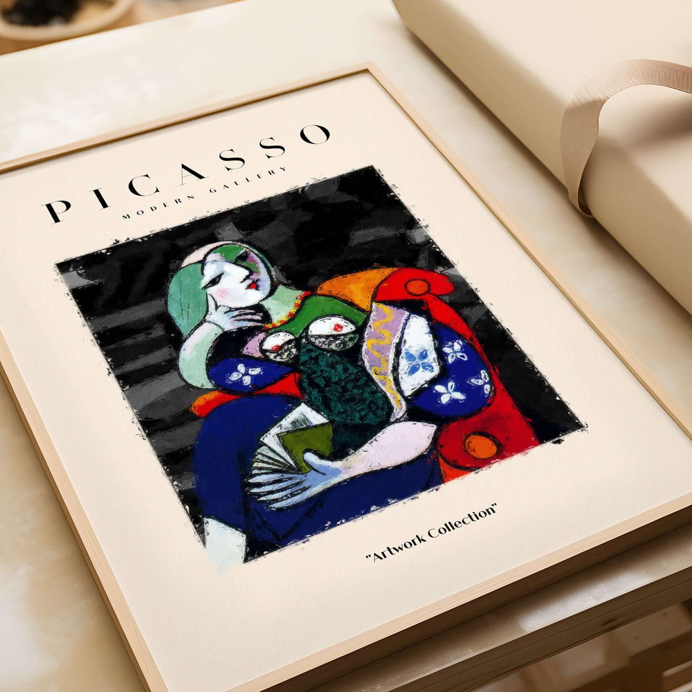 Picasso Seated Woman Reading Abstract Figure Art Print Modern Gallery Artwork Poster in a stylish frame on a table.