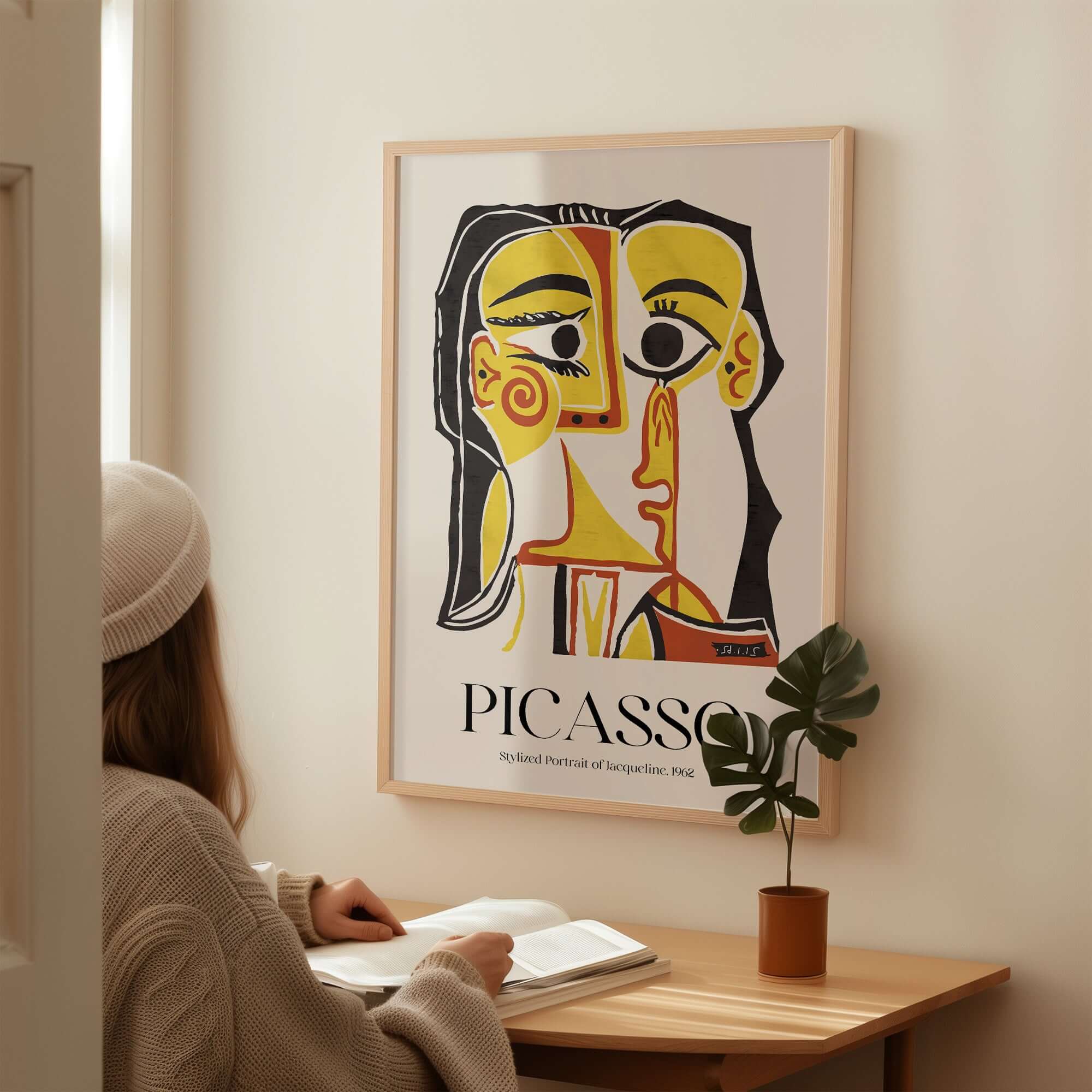 Picasso Stylized Portrait Jacqueline 1962 Abstract Art Print Yellow Red Poster displayed on a wall beside a person reading.