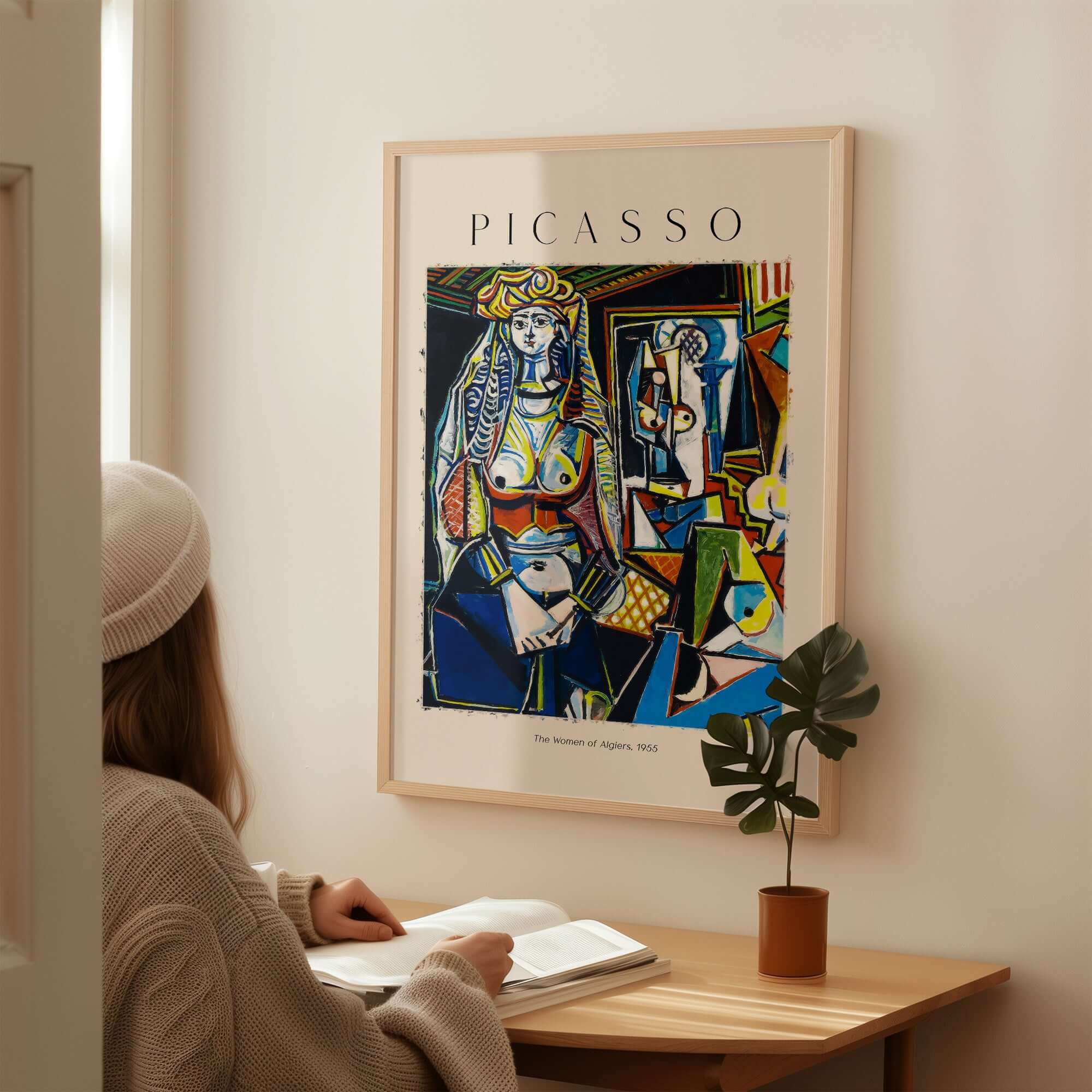 Picasso The Women of Algiers 1955 Art Print Famous Cubist Painting Poster Wall Art displayed beside a woman reading.
