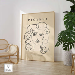 Picasso Woman Curly Hair Line Art Abstract Portrait Poster Modern Gallery Wall Art displayed in a stylish room with plants.
