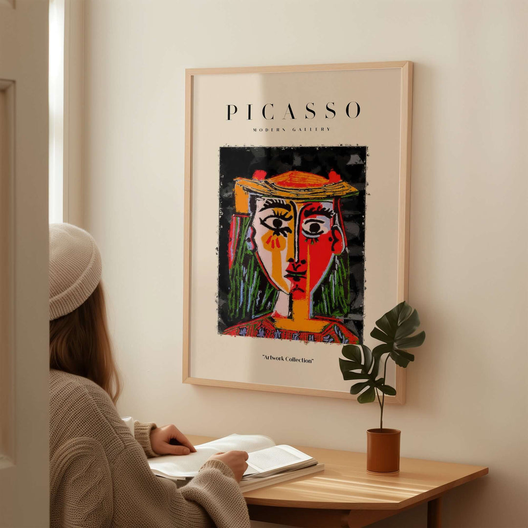 Colorful abstract portrait poster of a woman in hat by Picasso, featuring red and yellow sections, displayed in a modern interior.