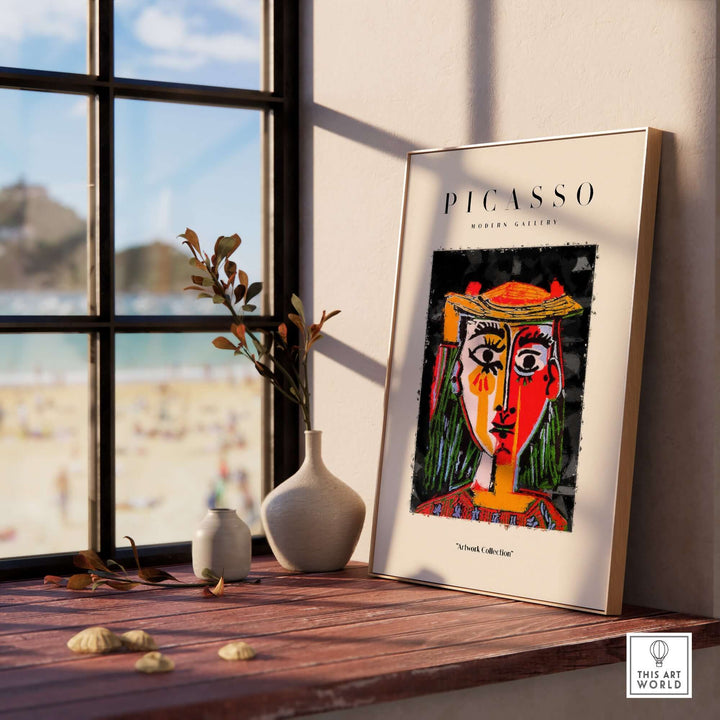 Colorful abstract portrait poster of a woman in hat by Picasso, displayed in modern interior with beach view.