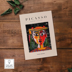 Picasso Woman in Hat Red Yellow Face Portrait Poster Colorful Abstract Artwork Print displayed on wooden background.