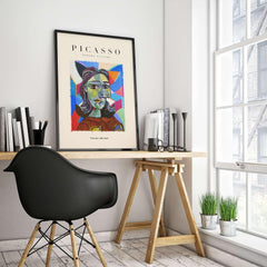 Picasso Woman Portrait Fragmented Abstract Poster Colorful Artwork Print Modern Gallery on wall above a wooden desk.