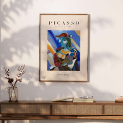 Picasso Woman Red Hat Blue Face Portrait Print Colorful Cubist Poster Artwork Collection displayed on a wall.