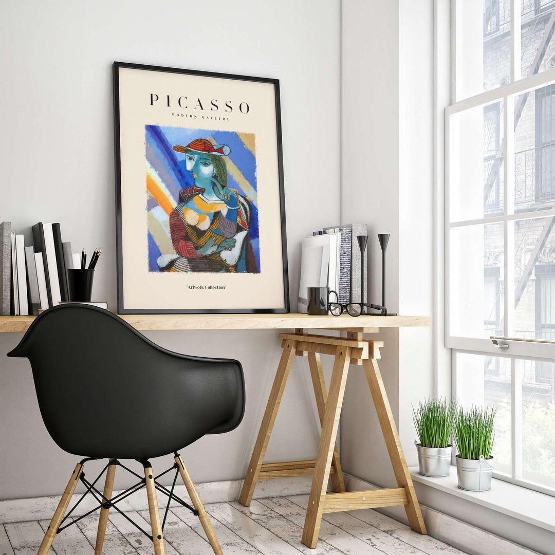 Picasso-inspired colorful Cubist portrait print of a woman with a blue face and red hat in modern office decor.