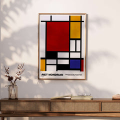 Piet Mondrian Composition Red Yellow Blue 1939 De Stijl Poster Geometric Abstract Print on wall above wooden furniture.