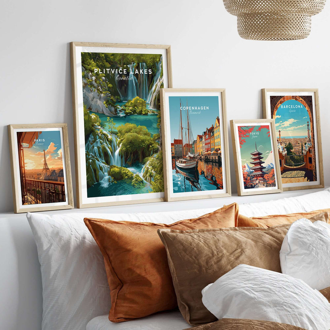 Collection of framed travel posters featuring Plitvice Lakes, Copenhagen, and Barcelona in a stylish living space.