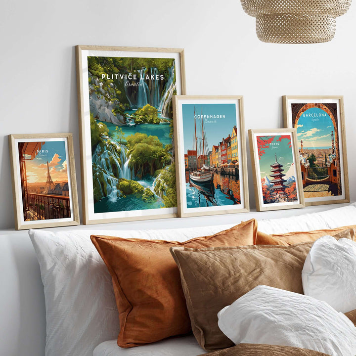 Collection of framed travel posters featuring Plitvice Lakes, Copenhagen, and Barcelona in a stylish living space.