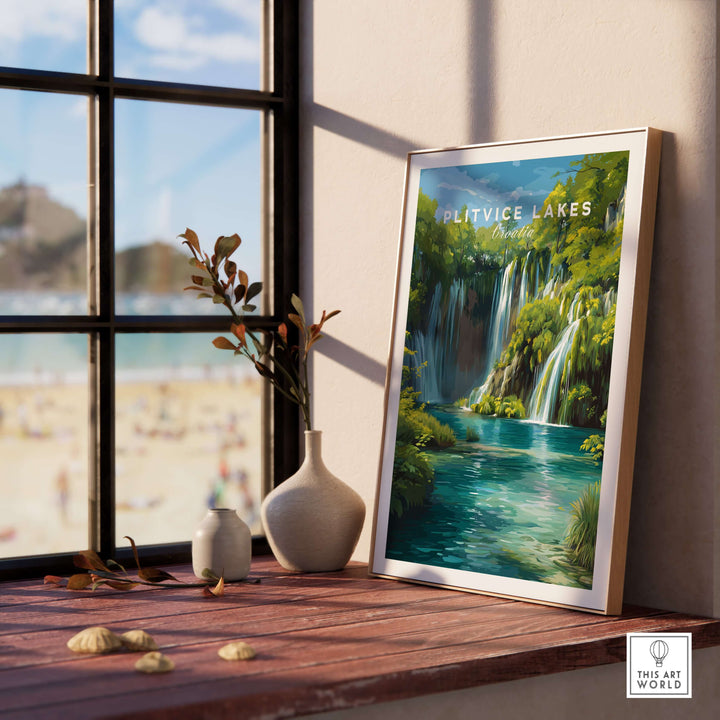 Plitvice Lakes National Park art print displayed on a wooden table by a window, showcasing vibrant waterfalls and lush greenery.