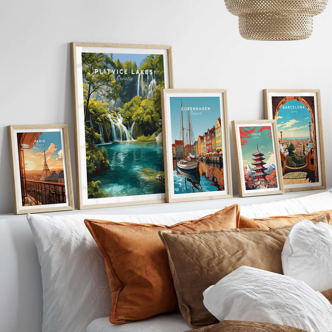 Collection of travel posters including Plitvice Lakes, Copenhagen, and Barcelona displayed on a stylish wall.