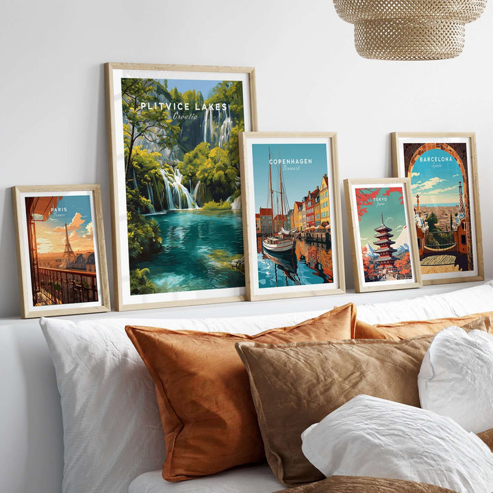 Collection of travel posters including Plitvice Lakes, Copenhagen, and Barcelona displayed on a stylish wall.