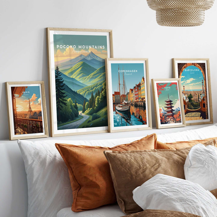 Collection of travel posters including Pocono Mountains, Copenhagen, and Barcelona in stylish frames.