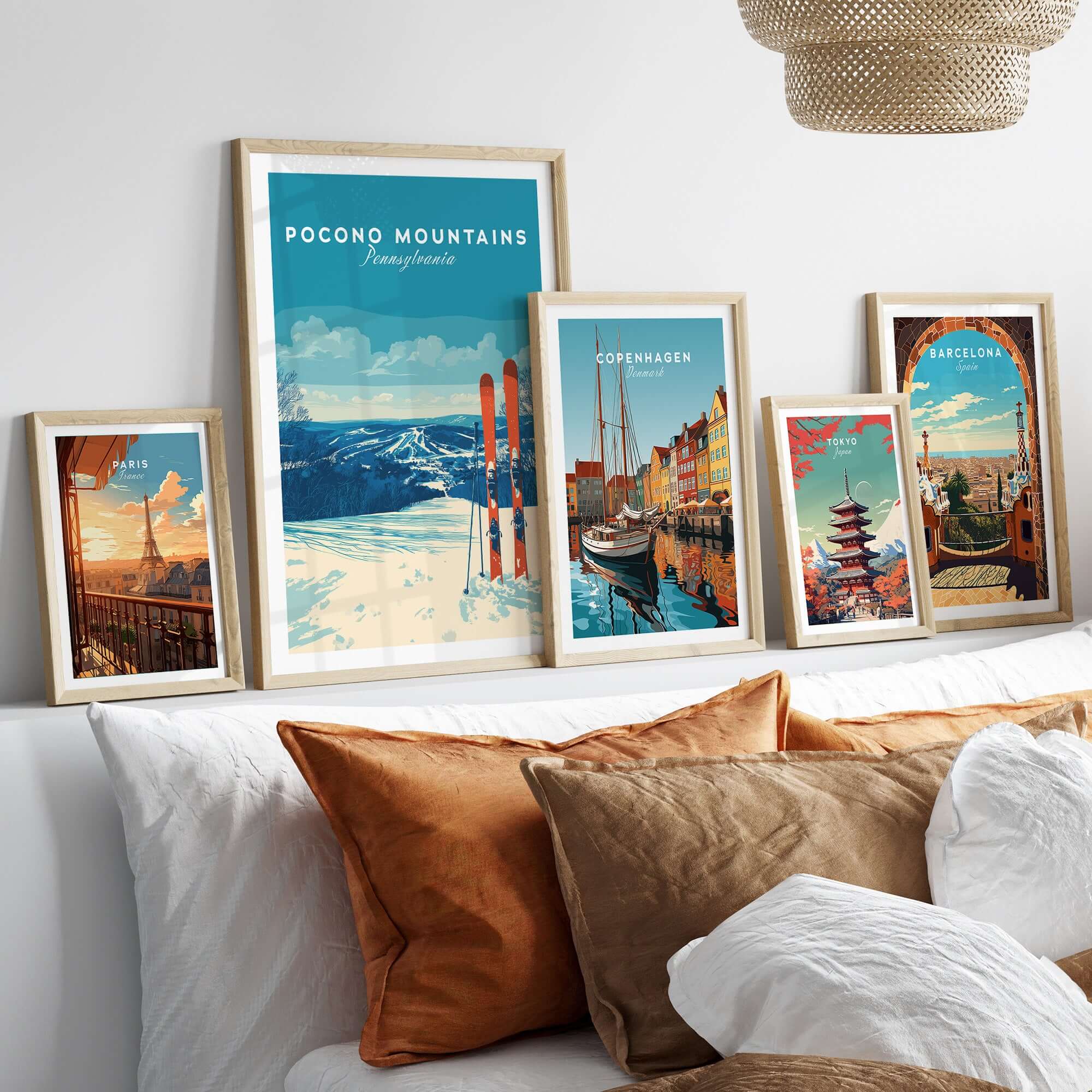 Pocono Mountains ski resort poster and travel prints displayed on a cozy bed with decorative pillows.